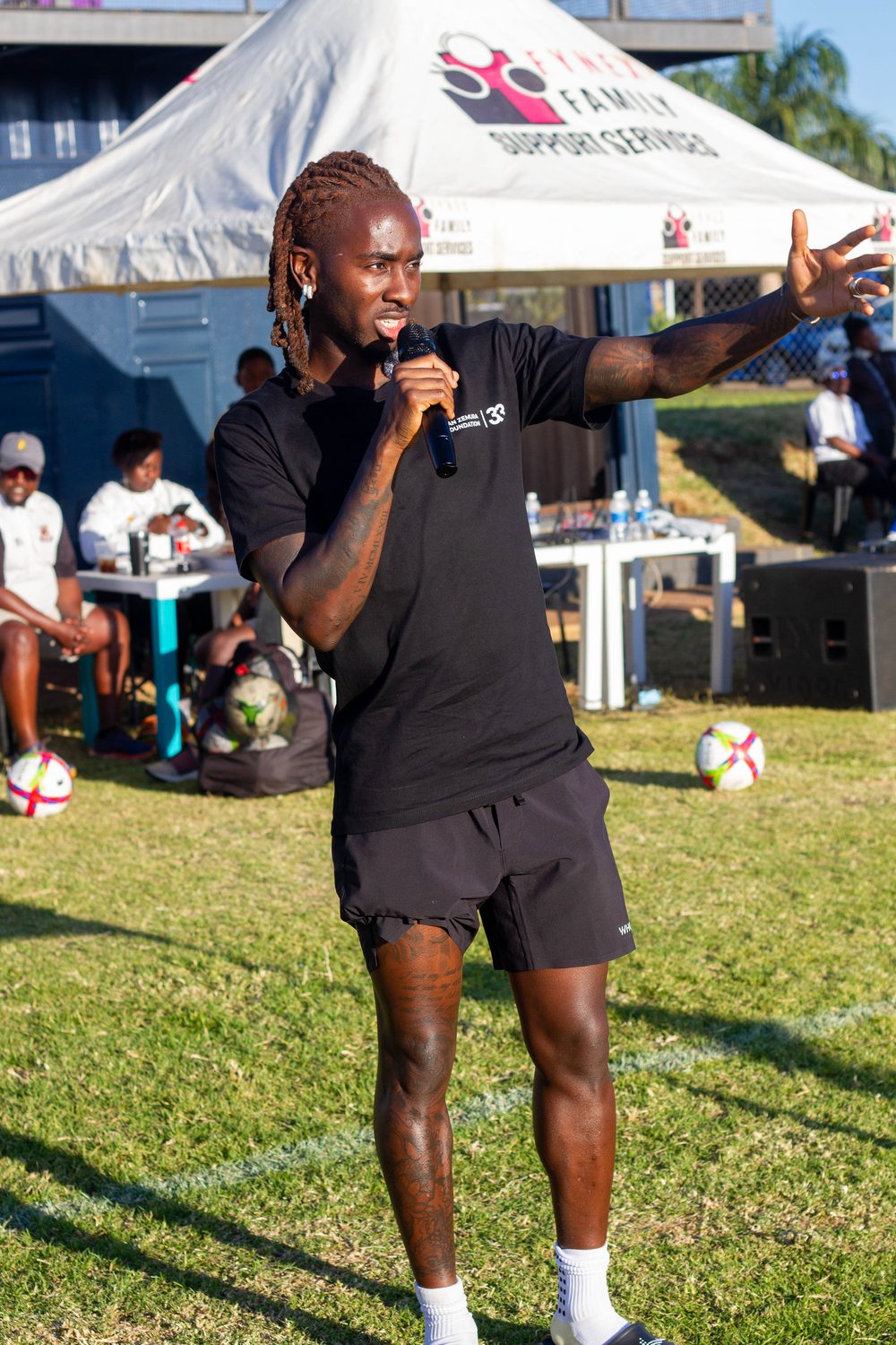 Jordan Zemura speaking at a community event